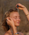 Pitta Dosha Drops being applied to face