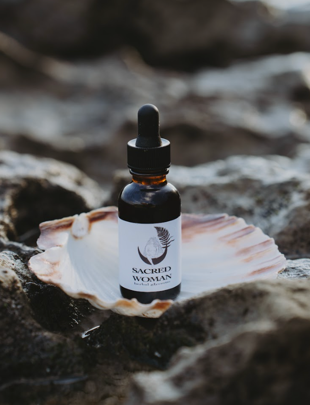 Sacred Woman Tincture herbal blend in glass dropper bottle for hormonal balance, cycle support, and feminine wellness
