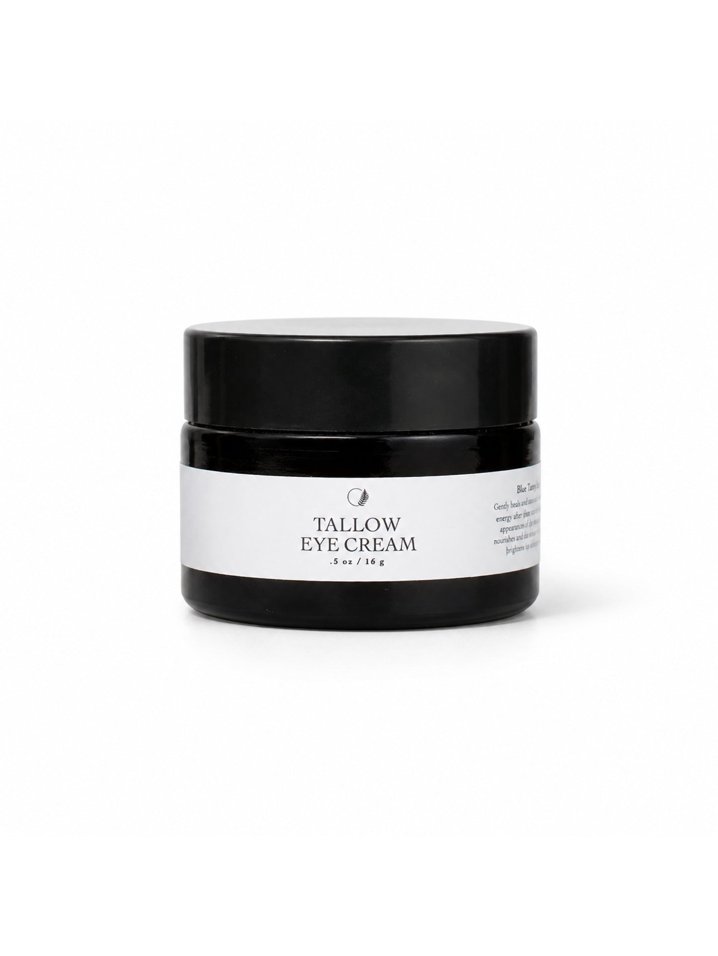 A black cosmetic jar of Tallow Eye Cream by Come Alive Herbals. with a white label, centered on a clean white background.