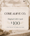 Come Alive Co. $100 digital gift card for herbal self-care, displayed on a cream card with botanical accents, dried herbs, and luxury wellness styling.
