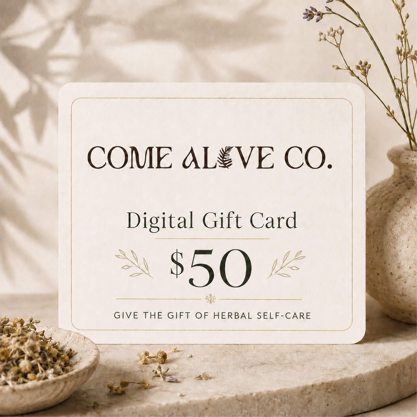 Come Alive Co. $50 digital gift card for herbal self-care, displayed on a cream card with botanical accents, dried herbs, and luxury wellness styling.