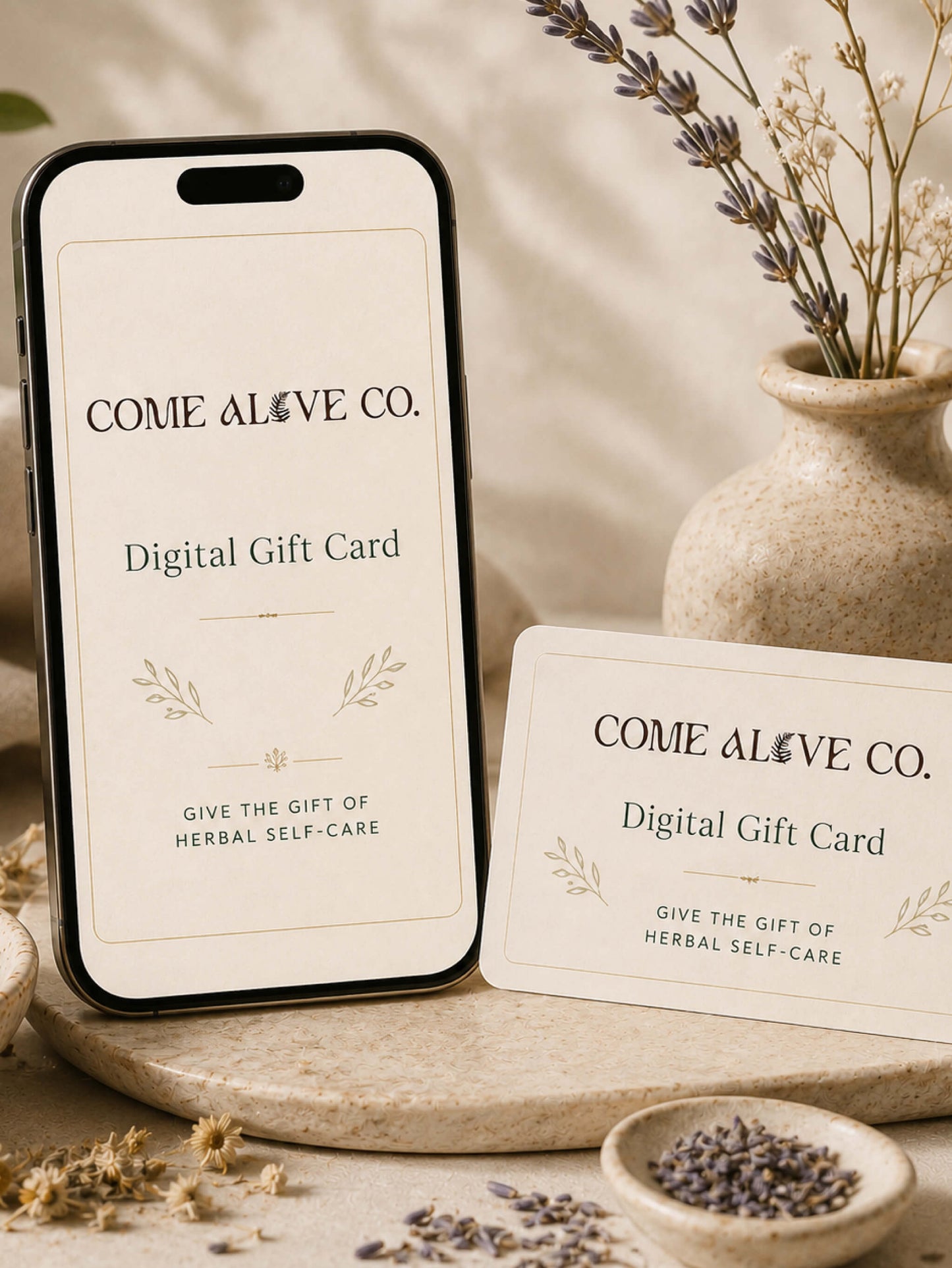 Come Alive Co. digital gift card for herbal self-care, displayed on a cream card with botanical accents, dried herbs, and luxury wellness styling.